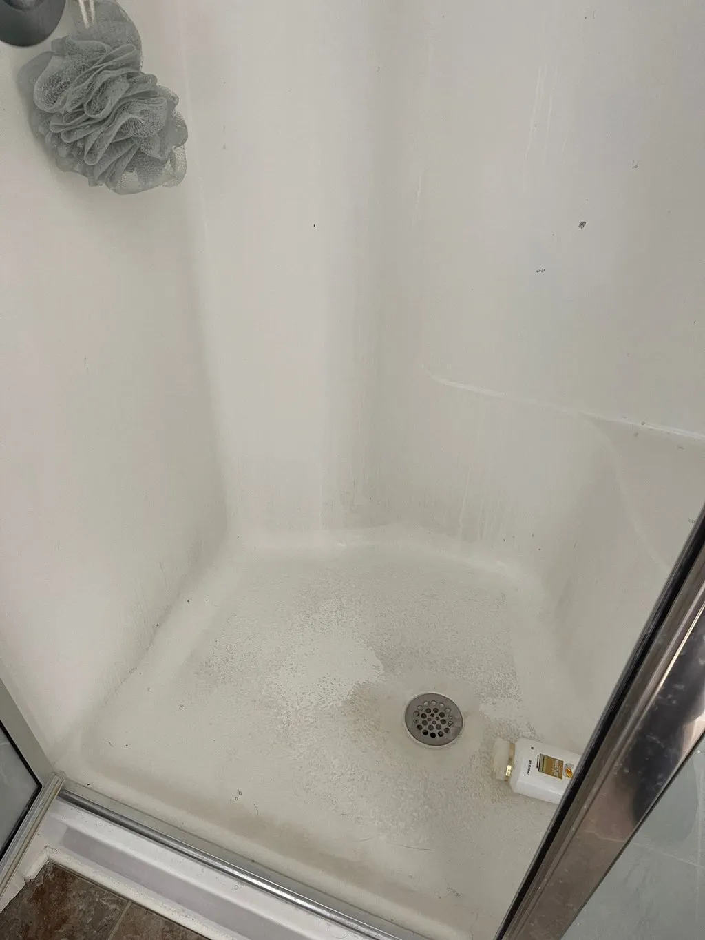 Shower before deep cleaning, with soap scum and grime