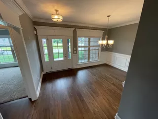 Spotless dining room with hardwood floors after house cleaning