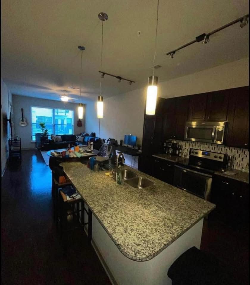Same kitchen after cleaning, clear counters and tidy